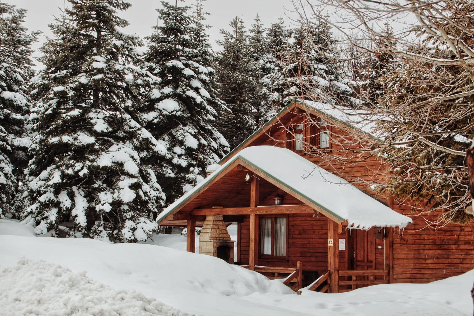 Snow-covered cabin kept warm through winter